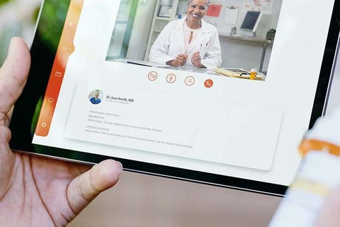 A person uses telehealth for a video visit with their medical provider using a tablet computer